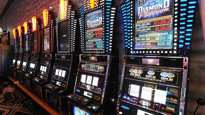 Slot machines line the walls at the Tiverton Casino.