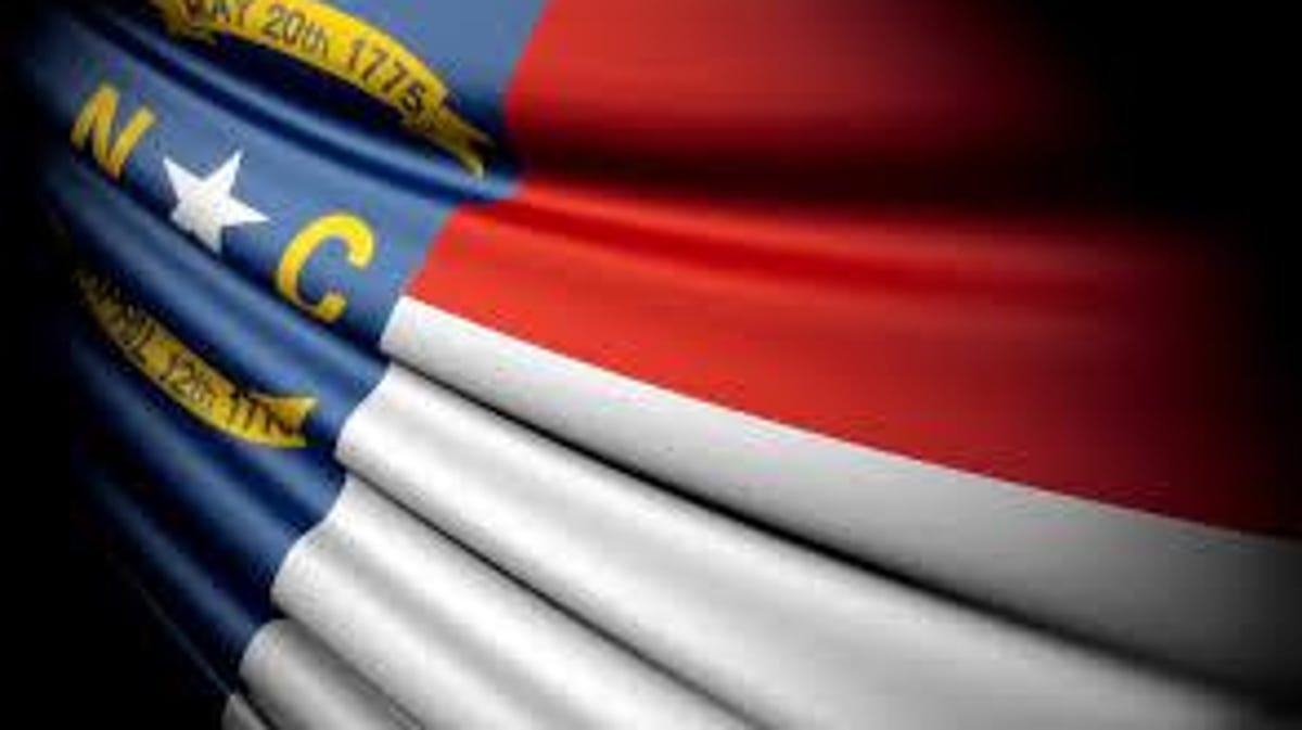 Why are flags flying at half-staff in North Carolina?