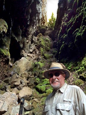 Jan Stafl poses at Hell Hole, a 200-foot-deep slot, just 20 feet wide, that extends perhaps 400 feet. Location is a well-kept secret because of the danger of the area.