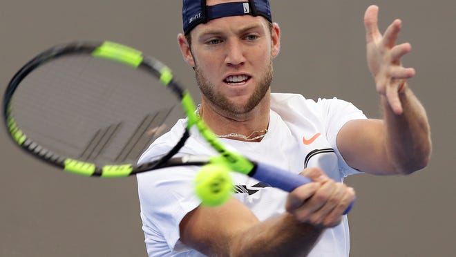 FILE - In this April 7, 2017, file photo, Jack Sock, of the United States, plays a shot in his match against Jordan Thompson, of Australia, at the Davis Cup World Group quarterfinals in Brisbane, Australia. Sock will be competing in the French Open tennis tournament. (AP Photo/Tertius Pickard, File)