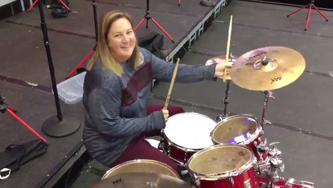 Bears head volleyball coach Melissa Stokes smiles for the camera after playing the drums at the MVC Championship in Normal, Illinois.