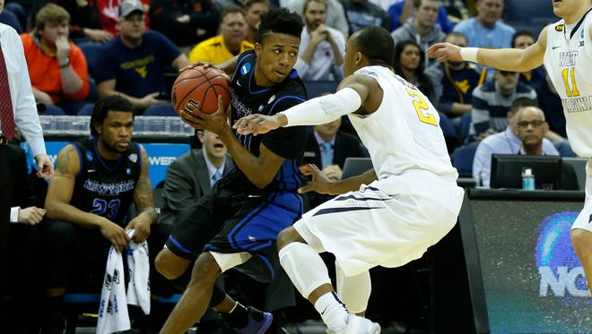 Buffalo guard Shannon Evans (11) works the ball against West Virginia guard Jevon Carter (2) during a second-round game of the 2015 NCAA Tournament.