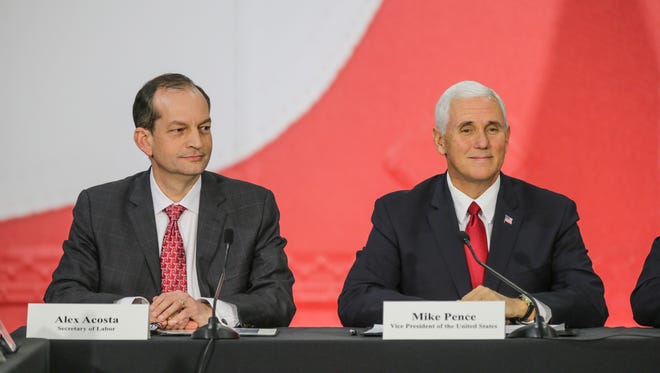 Secretary of Labor Alex Acosta, left, and Vice President of the United States Mike Pence, right, take part in a round table tax discussion during a visit to TKO Graphix in Plainfield Ind. on Thursday, Nov. 9, 2017.