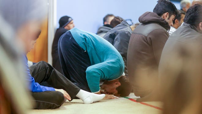 A man touches his head to the floor during Friday Prayer services, at Al Salam Foundation worship center in Indianapolis on Friday, Jan. 5, 2018.