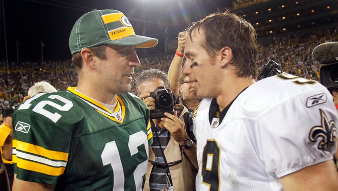 Packers quarterback Aaron Rodgers and New Orleans Saints quarterback Drew Brees following their 2011 season opener at Lambeau Field.