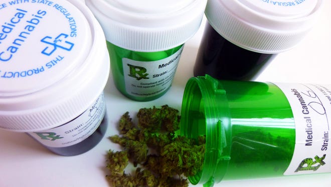 Close-up of four medical marijuana prescription containers.