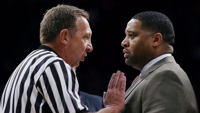 David Hall, left, referee talks with Book Richardson, assistant coach, during a timeout in the second half in a game at McKale Center on Sunday January 29, 2017. Arizona won 77-66.