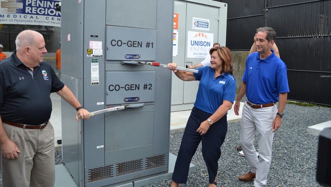 Gov. Larry Hogan and Peggy Naleppa flip the switch on new energy efficient combined heat and power plant at Peninsula Regional Medical Center on Friday.