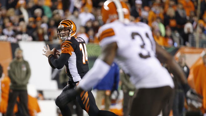 Cincinnati Bengals quarterback Andy Dalton (14) scrambles from the pocket and throws out of bounds against the Cleveland Browns at Paul Brown Stadium.