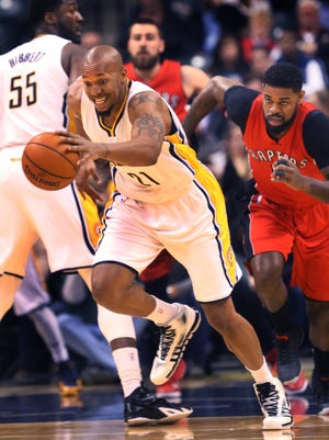 Indiana Pacer David West comes away with a first-half steal from Toronto Raptor Amir Johnson (right) as he was passing to a teammate at Bankers Life Fieldhouse in Indianapolis on Tuesday, Jan. 27, 2015. The Raptors led the Pacers 50-44 at the half.