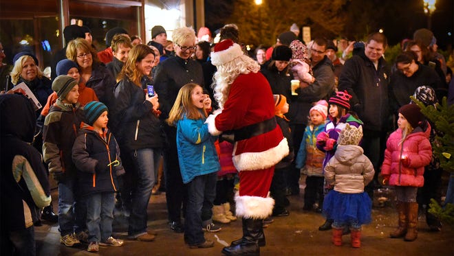 Children react with excitement as Santa Claus arrives Friday for the tree lighting ceremony as part of the Winter Walk in St. Joseph. 