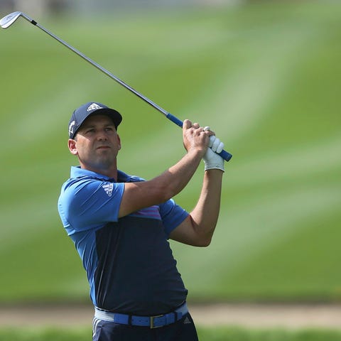 Sergio Garcia of Spain plays a shot on the 14th...