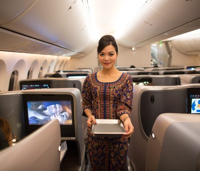 A flight attendant prepares meals for passengers aboard Boeing's first 787-10 as the aircraft is on its delivery flight to launch customer Singapore Airlines on March 26, 2018.