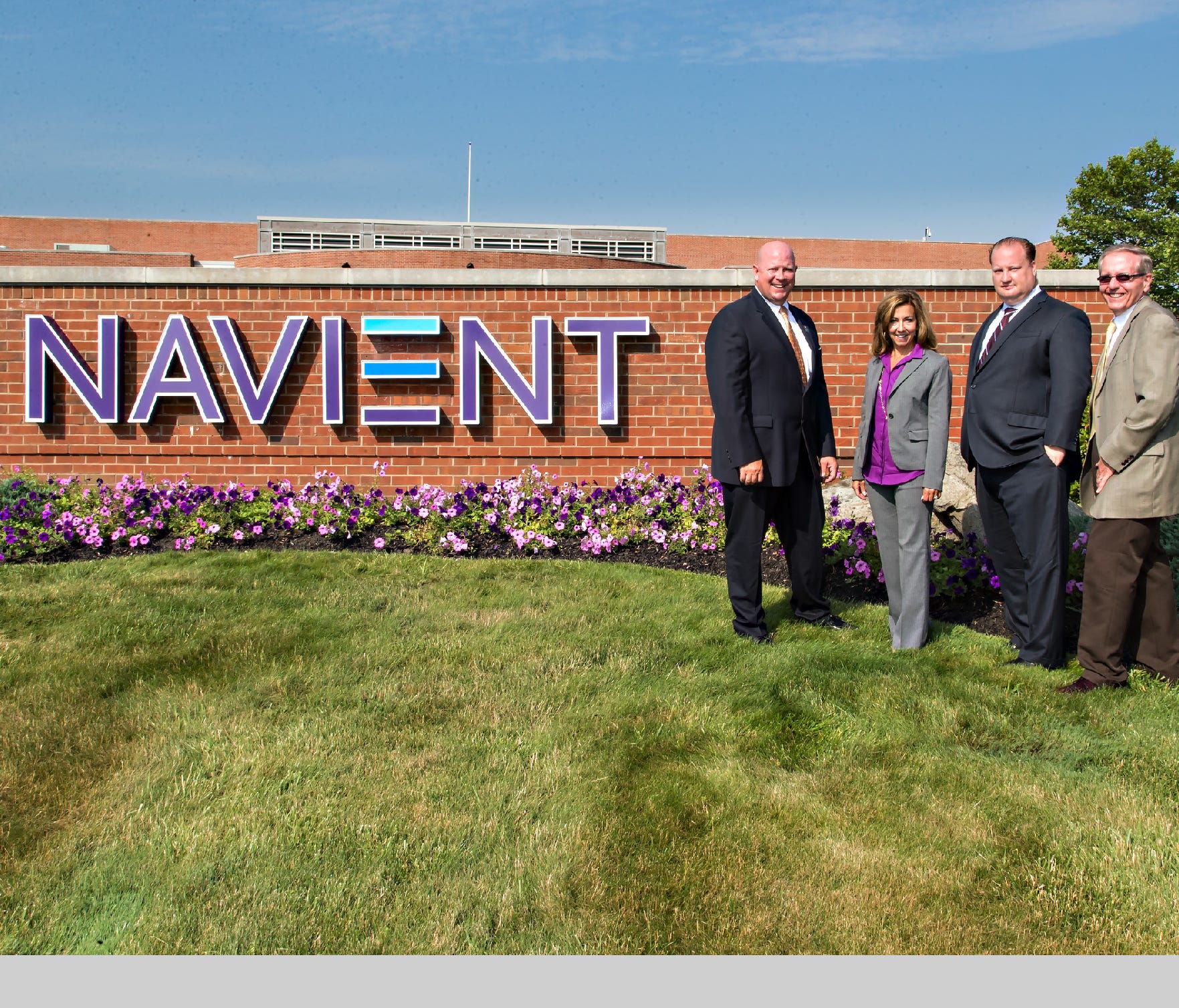 File photo taken in 2014 shows local officials and Navient unveiling a new sign for the nation's largest student loan servicing company.