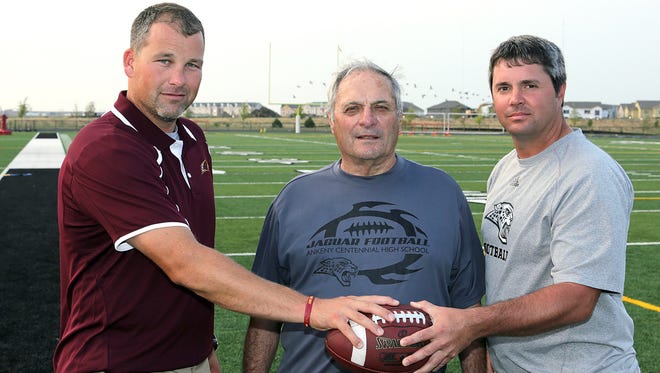 From left: Ankeny football coach Brad Zelenovich and Centennial co-coaches Jerry Pezzetti and Ryan Pezzetti.