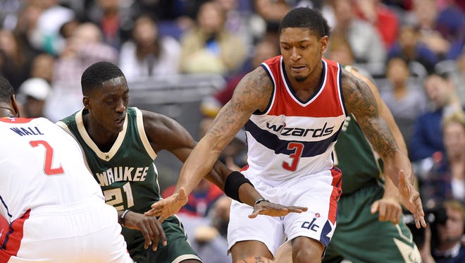 Washington Wizards guard Bradley Beal (right) battles for a loose ball against Milwaukee Bucks guard Tony Snell.