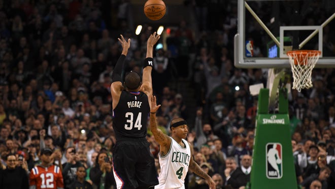 LA Clippers forward Paul Pierce (34) shoots a three point basket over Boston Celtics guard Isaiah Thomas (4) during the second half at TD Garden.