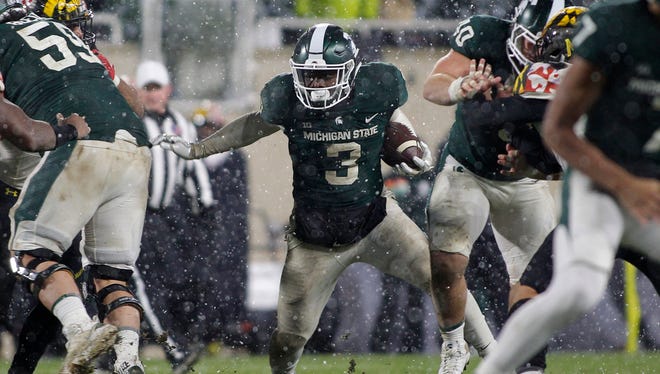 Michigan State's LJ Scott (3) rushes against Maryland during the second half.