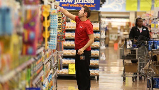 Matthew Lonzo stocks Coke products at the new Oakley Kroger Marketplace. The largest Kroger store in the country, it will bring 375 new jobs to the area.