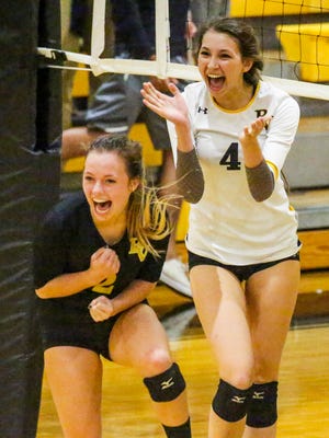 Bishop Verot players Mindie Mabry and Kelsey Sullivan celebrate a point asTampa Academy of Holy Names played Bishop Verot in their Region 5A-3 volleyball quarterfinal.