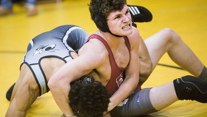 Westside sophomore Luke Sharp holds Hanna's Adonis Mundy in a headlock Tuesday at the Westside-T.L. Hanna wrestling competition in Anderson.