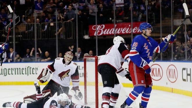 Arizona Coyotes goalie Adin Hill, above left, Adam Clendening, below left, and Alex Goligoski reacts as New York Rangers right wing Pavel Buchnevich (89) celebrates after scoring a goal during the second period of an NHL hockey game Thursday, Oct. 26, 2017, in New York. (AP Photo/Frank Franklin II)