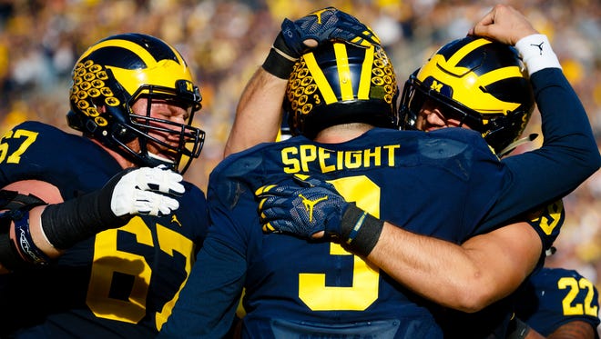 Michigan Wolverines quarterback Wilton Speight (3) receives congratulations from teammates after scoring a touchdown in the first half against the Maryland Terrapins at Michigan Stadium.