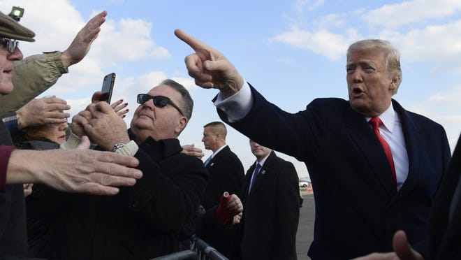 President Donald Trump greets people after arriving via Air Force One at Philadelphia International Airport in Philadelphia, Saturday, Dec. 8, 2018. Trump is attending the Army-Navy football game. (AP Photo/Susan Walsh)