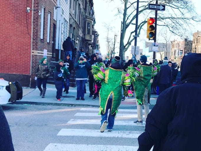 Fans decked out in Eagles green and Mummers sequins