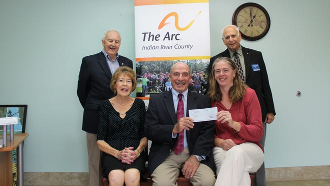 Heather Dales, seated, right, acting executive director of The Arc of Indian River County, accepts a check from Knights of Columbus representatives Cathy LaCroix, Robert Gross,  Tom LaRocca and Bob Borelli.