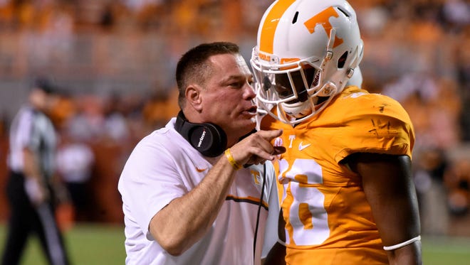 Tennessee coach Butch Jones talks with Stephen Griffin during a game in 2016.