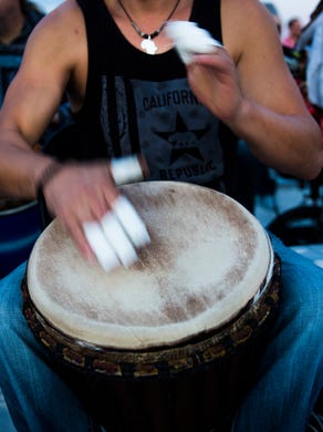 A drummer plays with taped fingers during the community drum circle at Siesta Key Beach on Sunday, January 21, 2018 in Sarasota. 