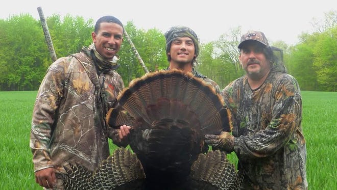 Tigers outfielder Anthony Gose and friends pose with a turkey lured last spring with Bob’s Custom Calls.