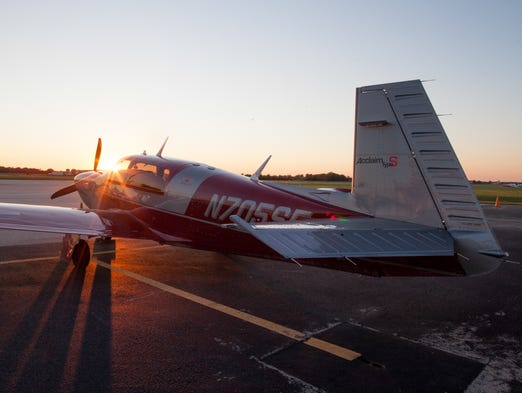 A Mooney Acclaim Type S rests on a farming Wisconsin