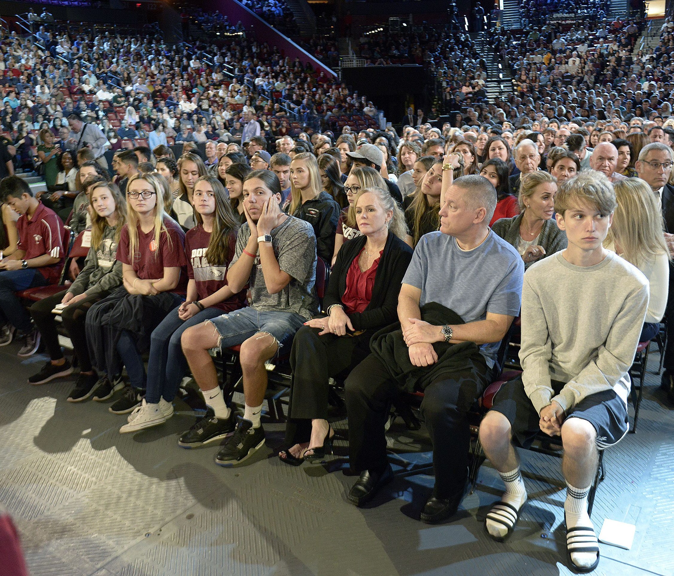 In this Wednesday, Feb. 21, 2018, file photo, Marjory Stoneman Douglas High School students and parents wait for a CNN town hall broadcast to begin at the BB&T Center in Sunrise, Fla.