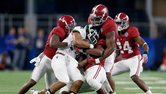 Alabama defensive tackle A'Shawn Robinson (86) makes a tackle against Michigan State in the Cotton Bowl.