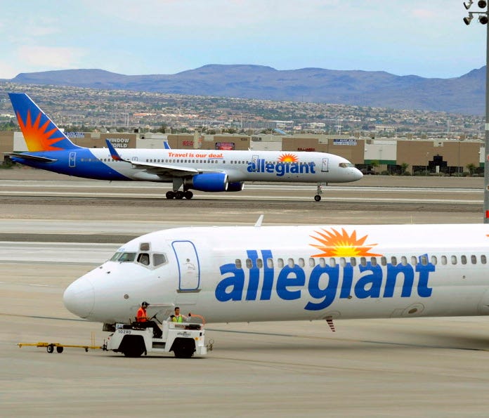 Two Allegiant Air jets taxi at McCarran International Airport in Las Vegas on May 9, 2013.