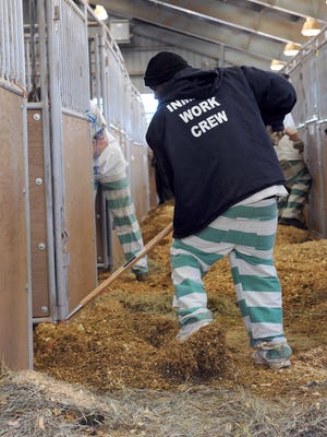 An inmate work crew supervised by the Hinds County Sheriffs Department clean barn 10 on the State Fairgrounds near downtown Jackson.