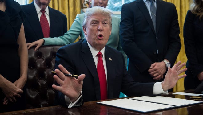 President Trump speaks before signing an executive order with small business leaders in the Oval Office on Jan. 30, 2017.