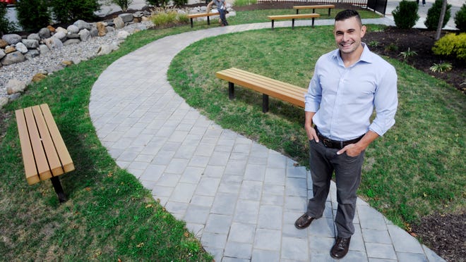 Jospeh Amendola is the winner of the Business Excellence award in the entrepreneur category. He stands in the pocket park on Market Street that he built.