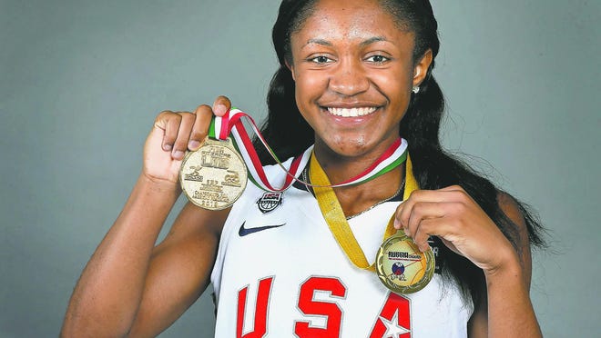 Blackman senior Crystal Dangerfield holds up her two gold medals that she won while competing with the Team USA basketball team.