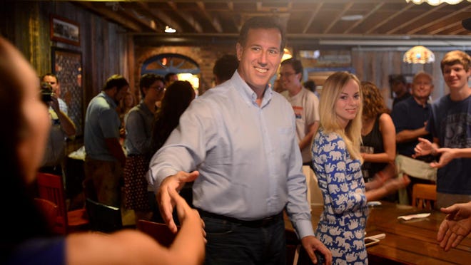 Republican presidential candidate Rick Santorum greets people at the Old Country Store on Friday afternoon.