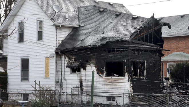 A home, damaged by a fire, is seen March 8, 2019, in Monroe. Authorities say over a dozen cats are believed to have died in the southeastern Michigan house fire. The cause is under investigation.