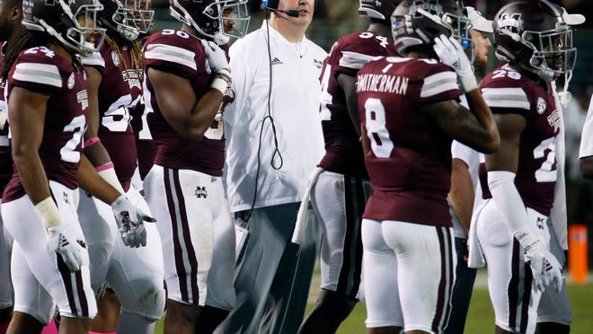 FILE - In this Saturday, Oct. 6, 2018, file photo, Mississippi State coach Joe Moorhead stands with his team during a timeout in the second half of their NCAA college football game against Auburn in Starkville, Miss. The SEC this week has been able to celebrate having the highest number of ranked teams within a single conference at any time in the past two years. Mississippi State went from unranked to 24th after defeating Auburn, which plummeted to 21st. (AP Photo/Rogelio V. Solis, File)