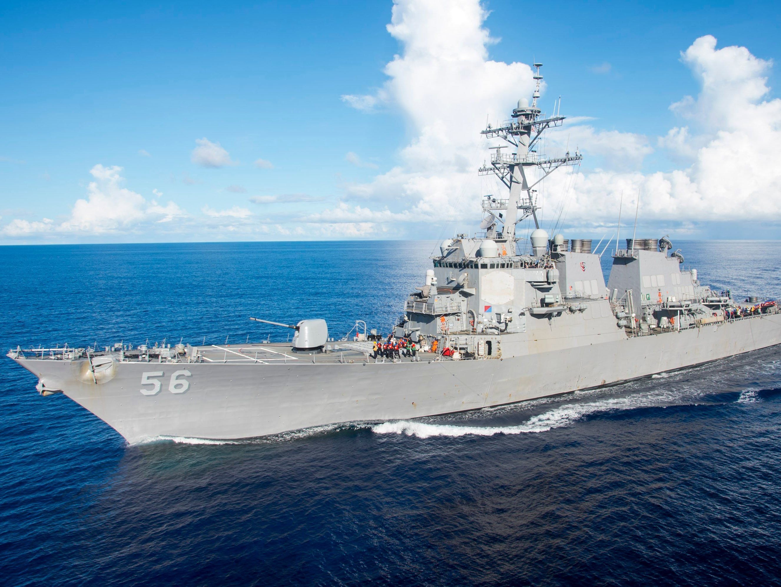 Arleigh Burke-class guided-missile destroyer USS John S. McCain maneuvers alongside the amphibious assault ship USS Bonhomme Richard (unseen) for refueling on the Philippine Sea on June 14, 2017.