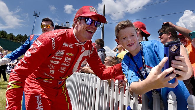 Scott Dixon enjoys a selfie with race fan Brady Schambaugh, 11, before the Honday Indy 200 at Mid-Ohio on Sunday.
