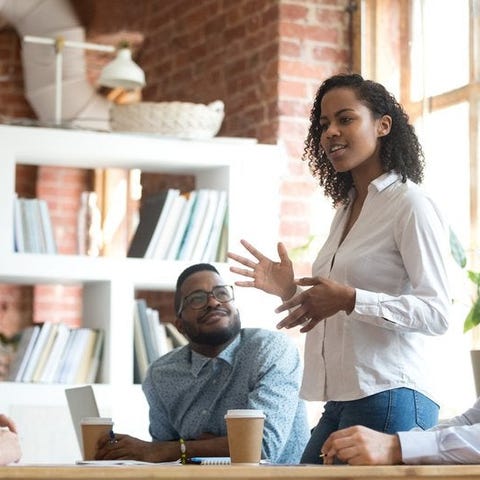 A woman leading a meeting in an office.