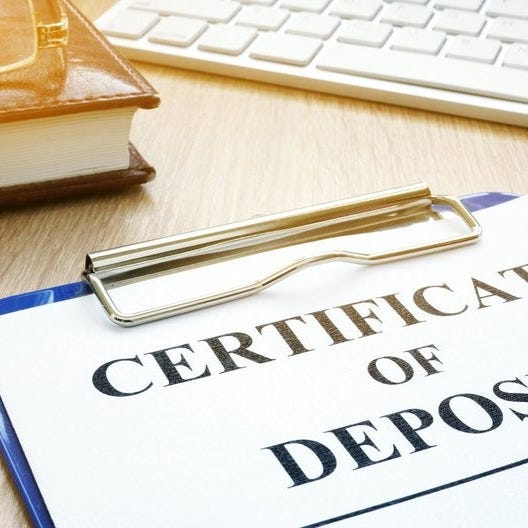 Certificate of deposit sign on a clipboard.
