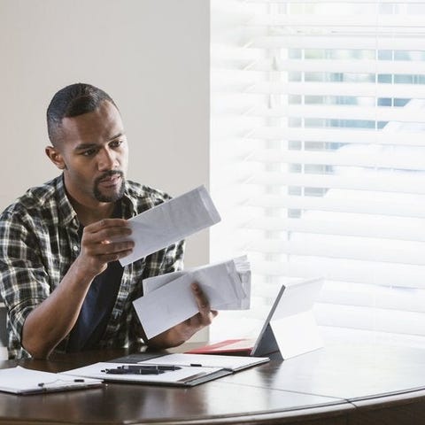 A man sitting at his dining table and opening a st