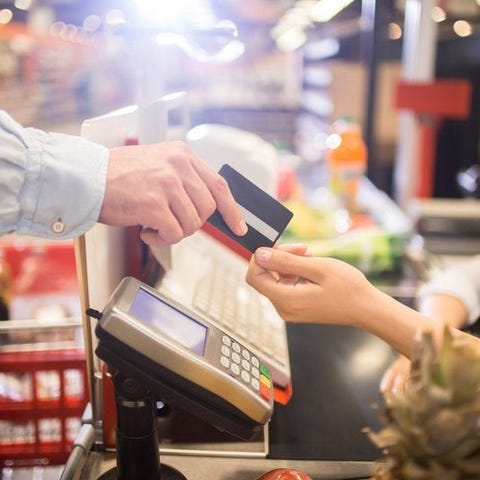 A man paying for groceries with a credit card.